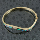Diamond and opal bracelet in 14k gold by Hileman.